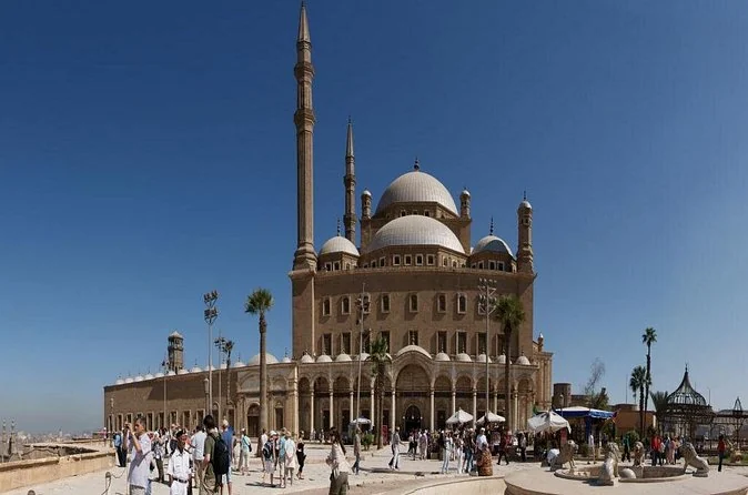 Visitors crossing the sunny forecourt in front of the Muhammad Ali Mosque on the Citadel