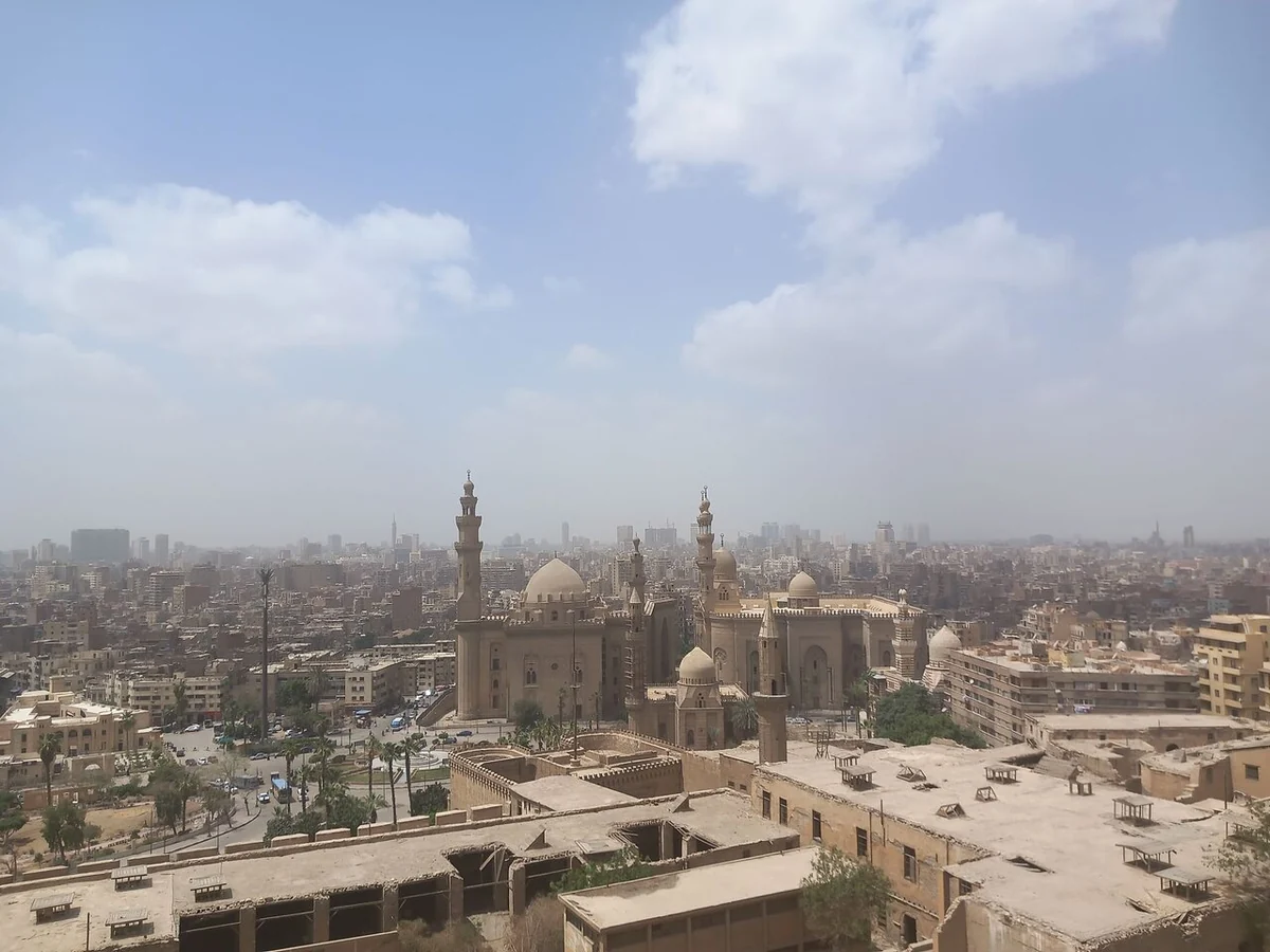 The Cairo skyline seen from the Citadel terrace, with Sultan Hassan and minarets in the haze